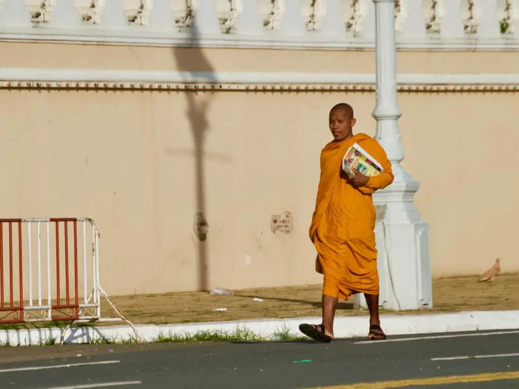 Buddhist monk walking near grand palace in the early morning, Phnom Penh Cambodia