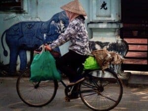 Woman cycling in Hanoi, Vietnam.