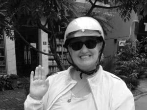 Anita is riding around Hanoi, Vietnam, on her moped (one of her favorite things to do).