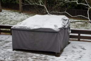 Covered patio furniture with snow
