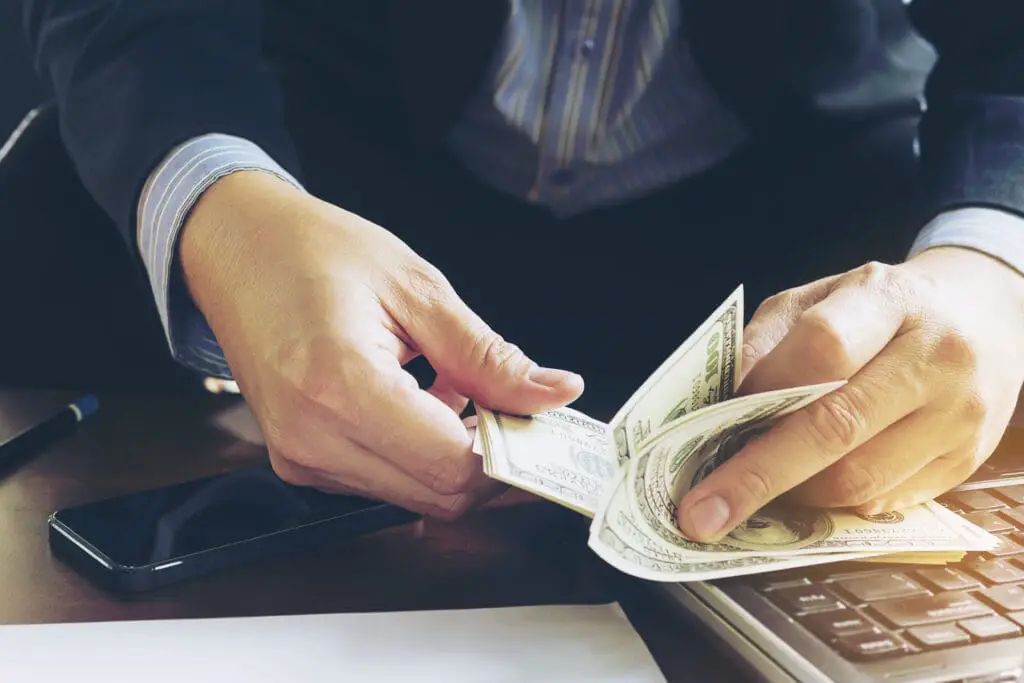 Businessman counting dollars.