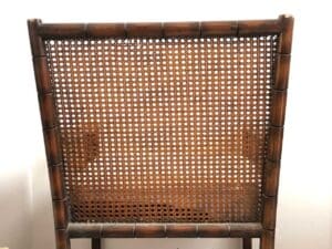 An old Shanghai rocking chair that has a woven seat.